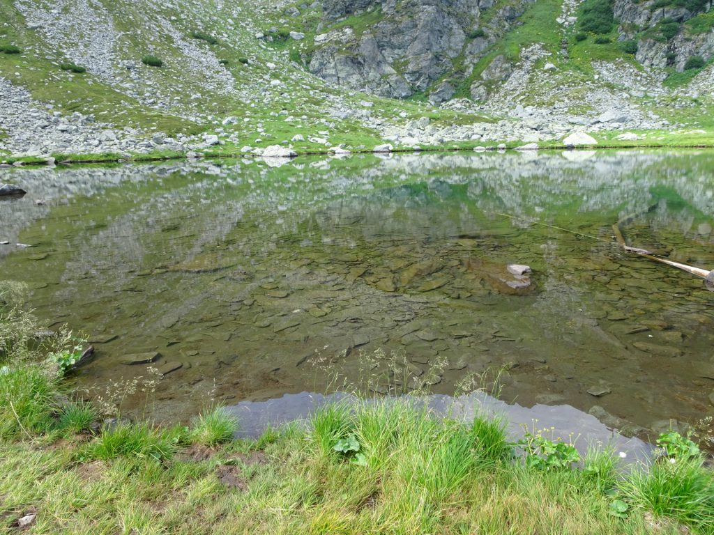 Amazing mirroring of the mountains in the clear water of the "Iezer" lake